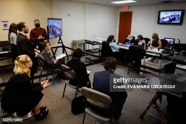 Election auditors work at the Miami-Dade County Election Department in Miami, Florida on October 19, 2020. Early voting kicked off Monday in Florida,...