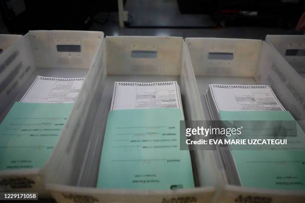Vote-by-mail ballots are seen at the Miami-Dade County Election Department in Miami, Florida on October 19, 2020. Early voting kicked off Monday in...