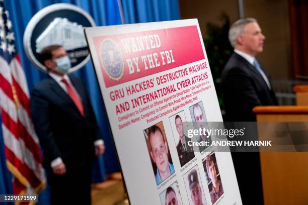 Poster showing six wanted Russian military intelligence officers is displayed as US Attorney for the Western District of Pennsylvania Scott Brady,...