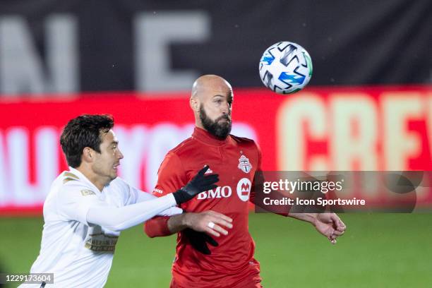 Toronto FC Defender Laurent Ciman heads the ball with Atlanta United FC Forward Erick Torres during the second half of a Major League Soccer match...