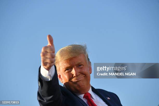 President Donald Trump gives a thumbs up as he leaves a rally at Tucson International Airport in Tucson, Arizona on October 19, 2020. US President...
