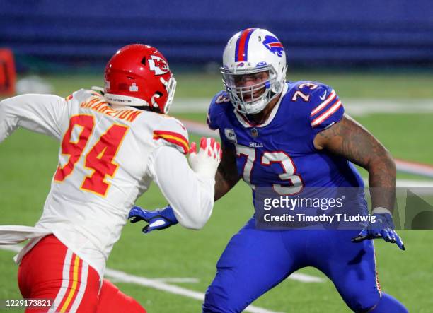 Dion Dawkins of the Buffalo Bills looks to make a block on Taco Charlton of the Kansas City Chiefs during the second half at Bills Stadium on October...
