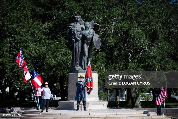 Braxton Spivey holds a confederate battle flag dressed in a Confederate army unifrom during a pro-Confederate flag protest by a group called "Flags...