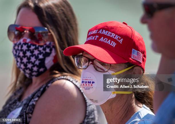 Supporters wear masks as they anticipate President Donald Trumps arrival on Air Force One at John Wayne Airport on Sunday, Oct. 18, 2020 in Santa...