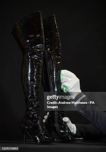 Vivian Ward's boots from the 1990 film 'Pretty Woman' are cleaned during a preview ahead of the Prop Store's Film and TV memorabilia Auction taking...