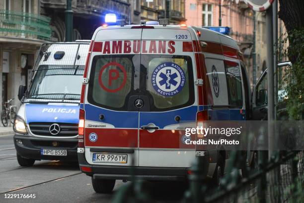 An ambulance and a Police van seen in Krakow's city center. The number of infected with COVID-19 in Krakow and the Lesser Poland Voivodeship is...