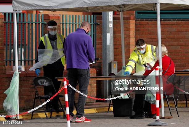 Member of the public attends a novel coronavirus COVID-19 testing facility set up at the Cattle Market in Kingston, south London, on October 20,...