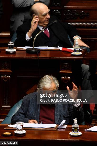 Uruguayan former presidents Julio Sanguinetti and Jose Mujica attend their last session as senators, at the Congress in Montevideo on October 20,...