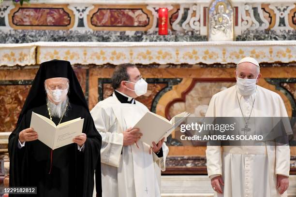 Pope Francis and the Ecumenical patriarch of Costantinople Bartholomew I both wearing a protective face mask, attend an inter-religious prayer...