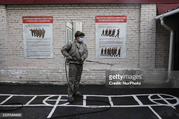 An employee of the radiation, chemical and biological protection troops de-sanitizes a military unit before the start of the draft season in the...