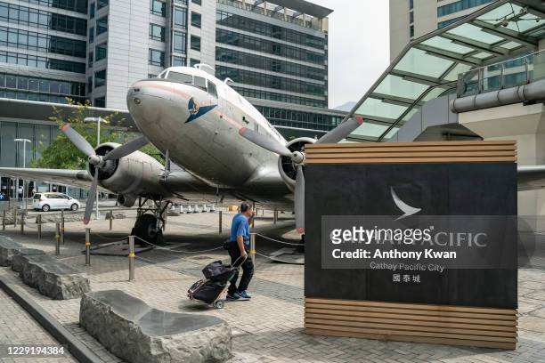 Man walks past Cathay Pacific City, the headquarters of Cathay Pacific Airways, on October 21, 2020 in Hong Kong, China. Hong Kong airline Cathay...
