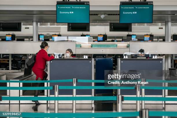 Cathay Pacific ground support workers at the check-in counter at the Hong Kong International Airport on October 21, 2020 in Hong Kong, China. Hong...