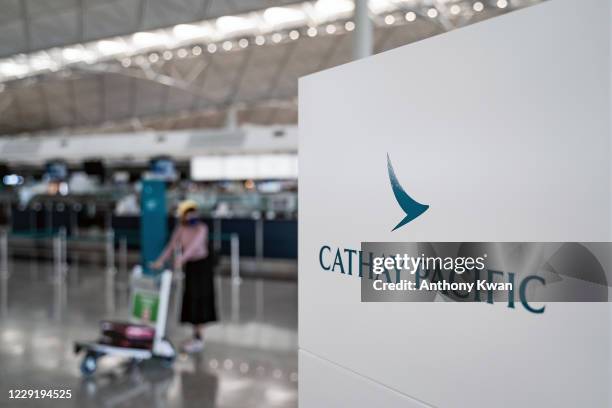 Signage of Hong Kong airline Cathay Pacific is displayed near check-in counter at the Hong Kong International Airport on October 21, 2020 in Hong...