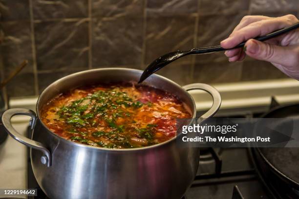 October 15: Oksana Chadaieva stirs the borscht that she just cooked in her kitchen in Kyiv, Ukraine on October 15, 2020. Chadaieva loves to cook...