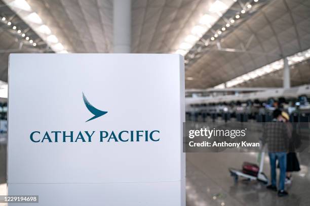 Signage of Hong Kong airline Cathay Pacific is displayed near check-in counter at the Hong Kong International Airport on October 21, 2020 in Hong...