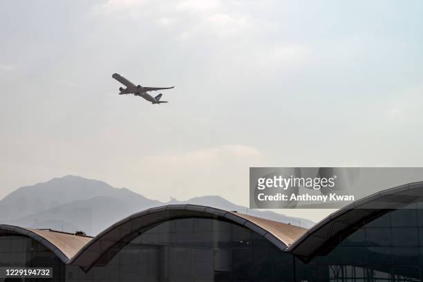 Cathay Pacific passenger jet takes off from Hong Kong International Airport on October 21, 2020 in Hong Kong, China. Hong Kong airline Cathay Pacific...