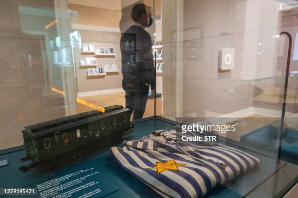 Visitor looks at items displayed at the Jewish Museum in Frankfurt am Main, western Germany, on October 21, 2020. - The Jewish Museum re-opened on...