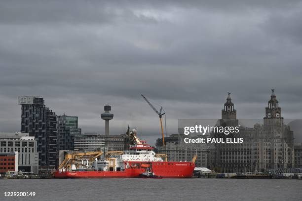 Polar research ship, the RRS Sir David Attenborough, sails to berth on the River Mersey with the Royal Liver Building and the Liverpool skyline in...