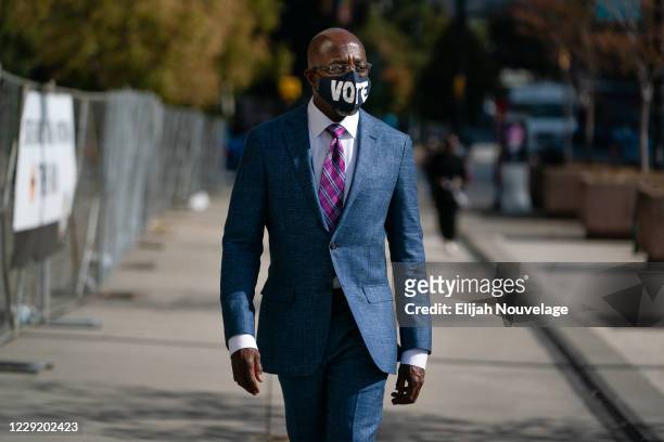 Democratic U.S. Senatorial candidate Raphael Warnock walks to State Farm Arena to cast his ballot on October 21, 2020 in Atlanta, Georgia. Warnock is...