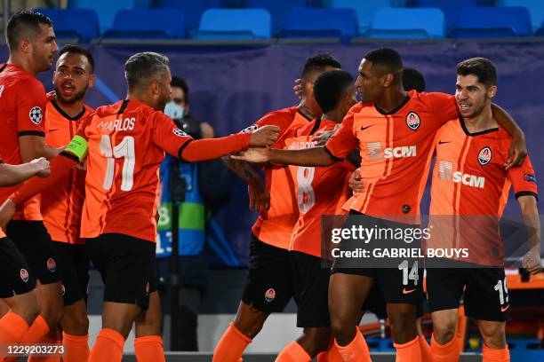 Shakhtar Donetsk's Brazilian forward Tete celebrates with teammates after scoring a goal during the UEFA Champions League group B football match...