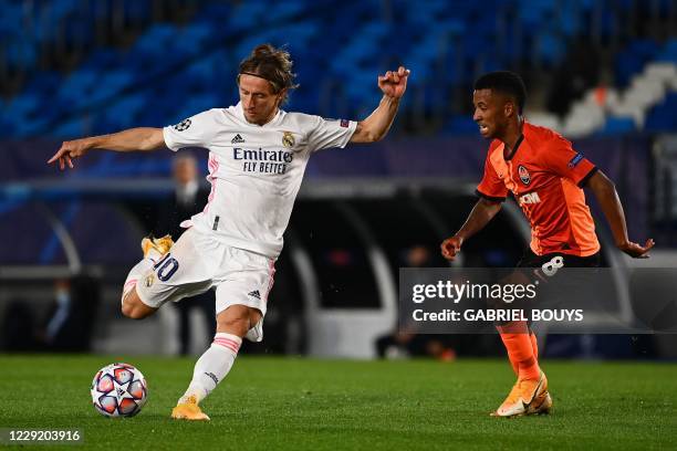 Real Madrid's Croatian midfielder Luka Modric scores a goal past Shakhtar Donetsk's Brazilian midfielder Marcos Antonio during the UEFA Champions...