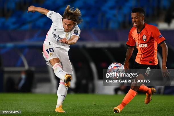 Real Madrid's Croatian midfielder Luka Modric scores a goal past Shakhtar Donetsk's Brazilian midfielder Marcos Antonio during the UEFA Champions...