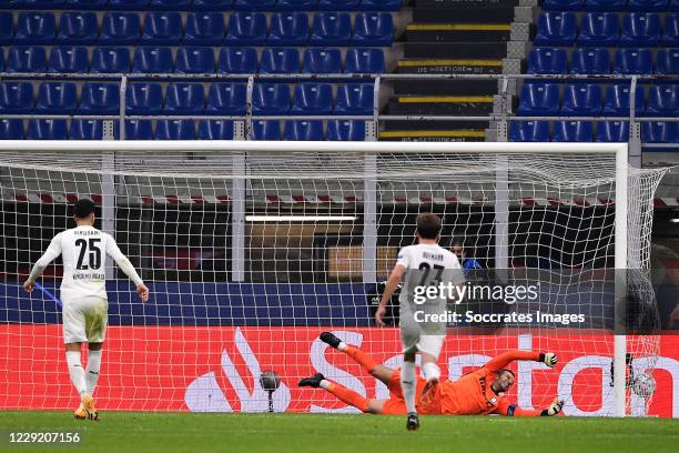 Ramy Bensebaini of Borussia Monchengladbach scores penalty by Samir Handanovic of Inter Milan during the UEFA Champions League match between...