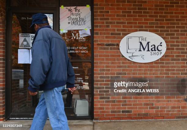 Man walks past "The Mac Shop" in Wilmington, Delaware on October 21, 2020. - The New York Post last week revived allegations against Hunter Biden...