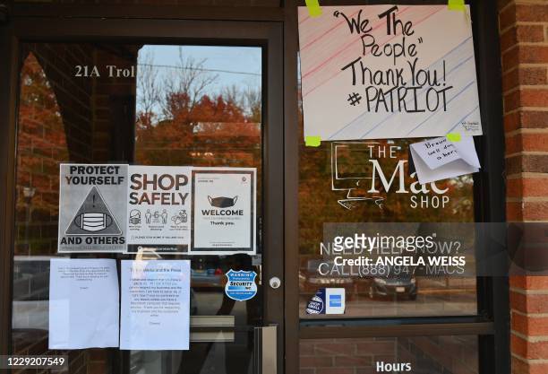Signs of support are posted outside "The Mac Shop" in Wilmington, Delaware on October 21, 2020. - The New York Post last week revived allegations...