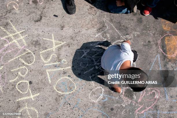 Child takes part in a protest of migrants and human rights activists against US and Mexican migration policies at the San Ysidro crossing port, in...