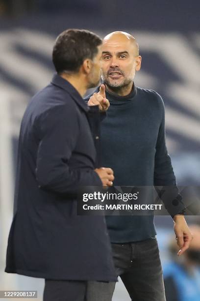 Manchester City's Spanish manager Pep Guardiola gestures as he exchanges words with Porto's Portuguese coach Sergio Conceicao during the UEFA...