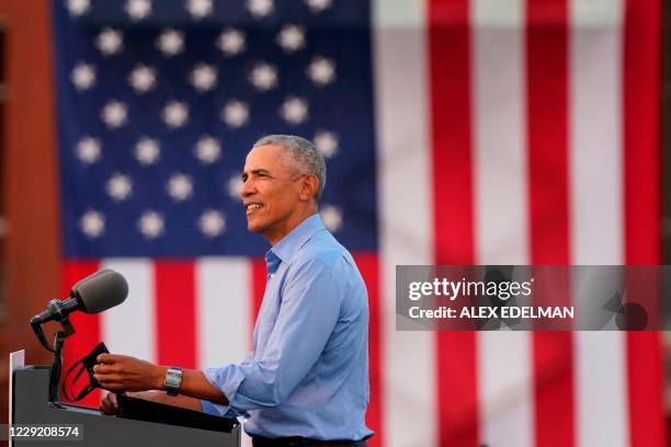 Former US President Barack Obama addresses Biden-Harris supporters during a drive-in rally in Philadelphia, Pennsylvania on October 21, 2020. -...