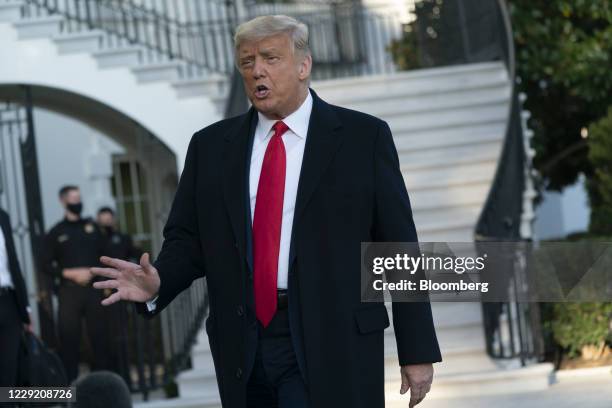 President Donald Trump speaks to members of the media before boarding Marine One on the South Lawn of the White House in Washington, D.C., U.S., on...