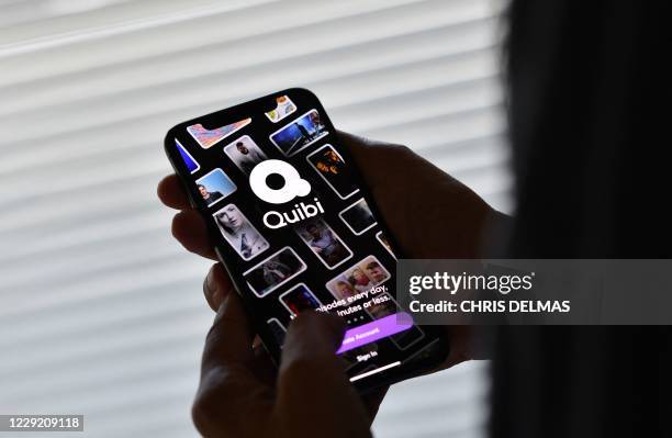 This illustration photo shows a person about to use the Quibi app on a smart phone in Los Angeles, October 21, 2020. - Quibi, the short video...