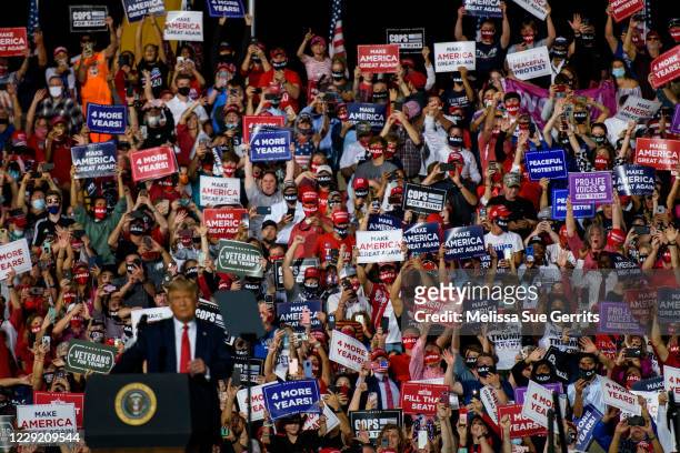 Crowd cheers for President Donald Trump as he arrives to make remarks during a rally at Gastonia Municipal Airport on October 21, 2020 in Gastonia,...