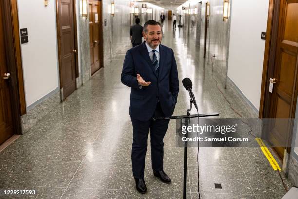Senator Ted Cruz talks to reporters before heading into a Judiciary Committee hearing where Republicans will vote on whether or not to move the...