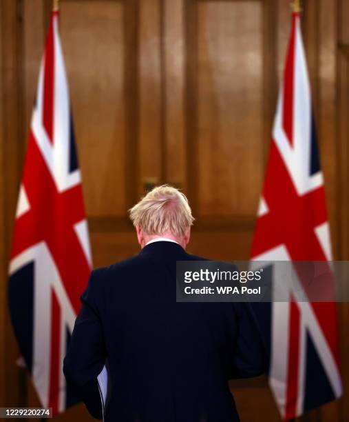 British Prime Minister Boris Johnson departs after addressing the nation during a news conference on the coronavirus at 10 Downing Street on October...