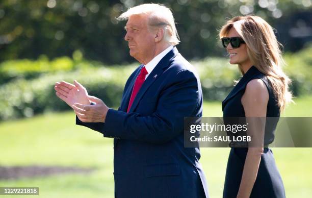 President Donald Trump and First Lady Melania Trump walk to Marine One prior to departing from the South Lawn of the White House in Washington, DC,...