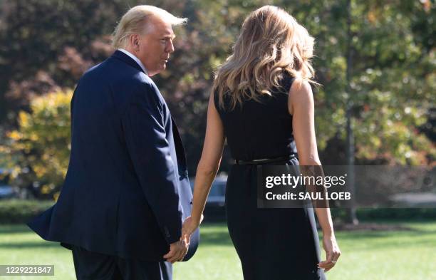 President Donald Trump and First Lady Melania Trump walk to Marine One prior to departing from the South Lawn of the White House in Washington, DC,...