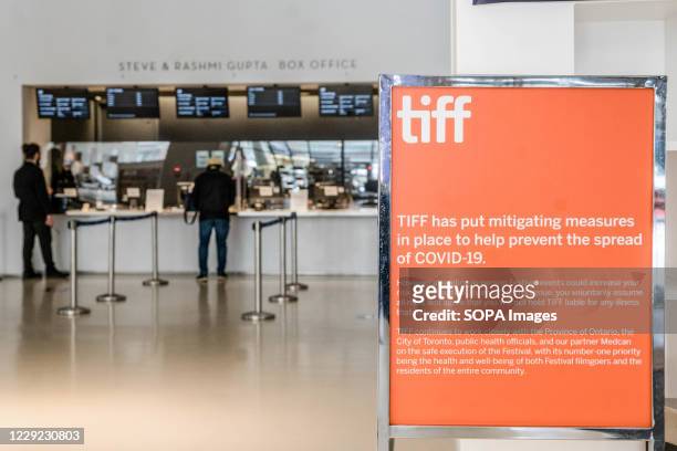 Covid 19 measures sign at TIFF Bell Lightbox which is nearly-empty during 2020 Toronto International Film Festival, mostly a virtual festival this...