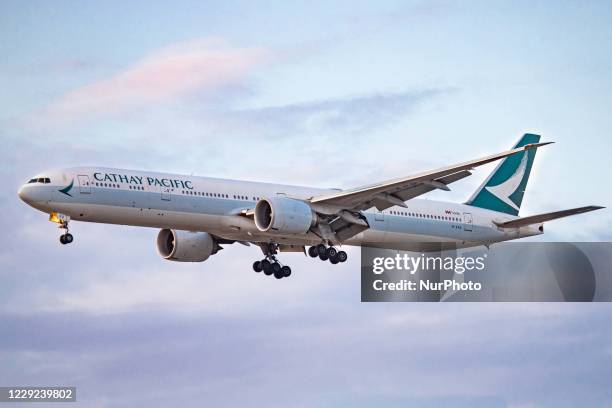 Cathay Pacific Boeing 777 aircraft as seen on final approach flying and landing at the north runway of London Heathrow International Airport LHR EGLL...