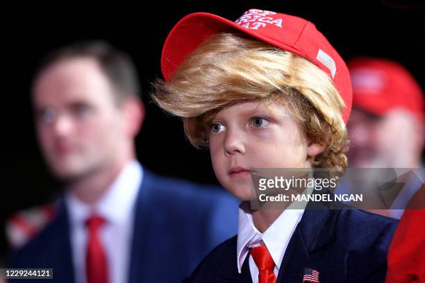 Young boy is dressed as US President Donald Trump during a campaign rally at Pensacola International Airport in Pensacola, Florida on October 23,...