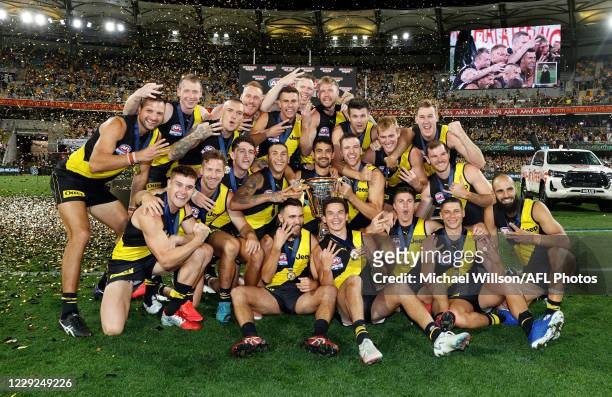The Tigers pose for their team photograph with the premiership cup during the 2020 Toyota AFL Grand Final match between the Richmond Tigers and the...