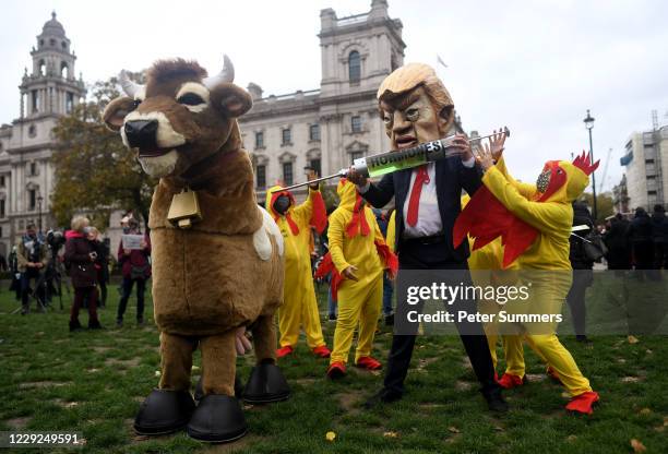 Protester dressed as U.S. President Donald Trump joins hundreds of anti-lockdown and anti-Trump protesters holding placards in Parliament Square for...