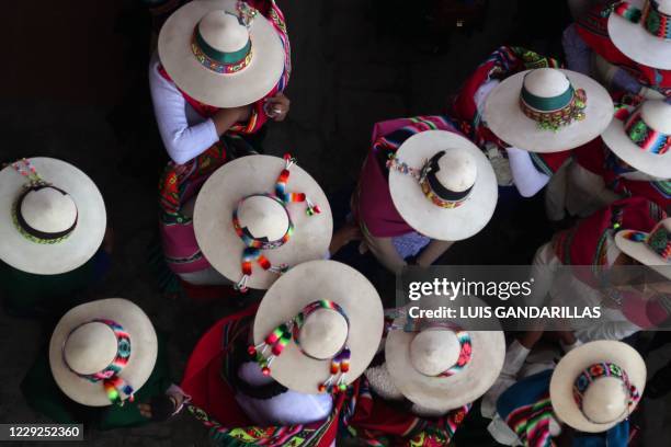 Supporters of Bolivian leftist presidential candidate Luis Arce of the Movimiento Al Socialismo , wait for his arrival to celebrate his victory of...