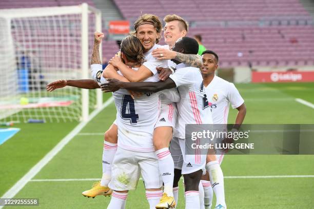 Real Madrid's Croatian midfielder Luka Modric celebrates with teammates after scoring a goal during the Spanish League football match between...