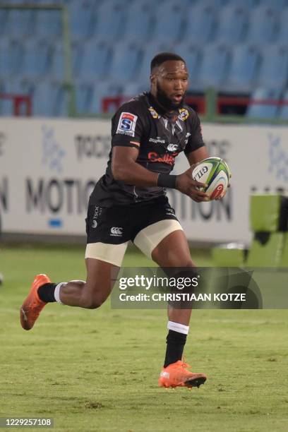 Sharks' captain Lukhanyo Am runs with the ball during the third round match in the South African Super Rugby Unlocked competition between the Vodacom...