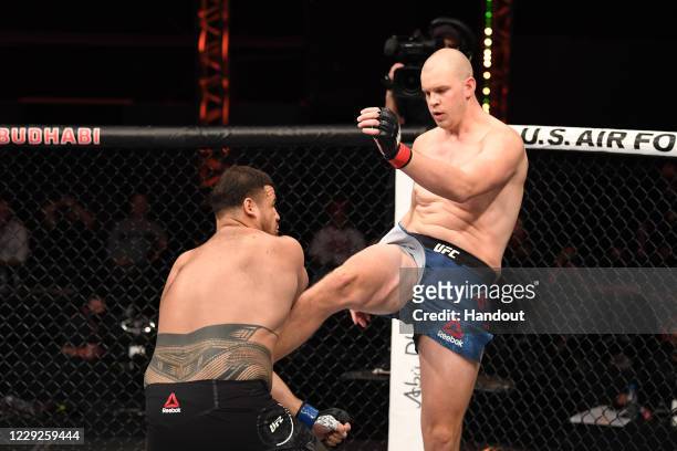 In this handout image provided by UFC, Stefan Struve of The Netherlands kicks Tai Tuivasa of Australia in their heavyweight bout during the UFC 254...