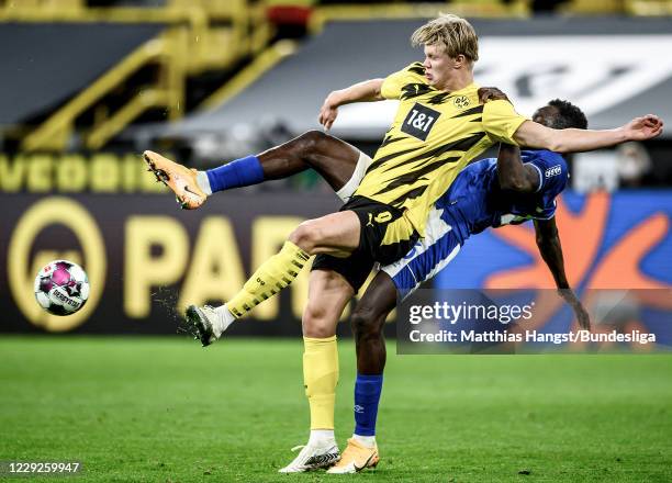 Erling Haaland of Borussia Dortmund in action against Salif Sane of Schalke during the Bundesliga match between Borussia Dortmund and FC Schalke 04...