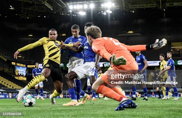 Manuel Akanji of Borussia Dortmund scores his team's first goal past Malick Thiaw of Schalke, Salif Sane of Schalke and goalkeeper Frederik Roennow...